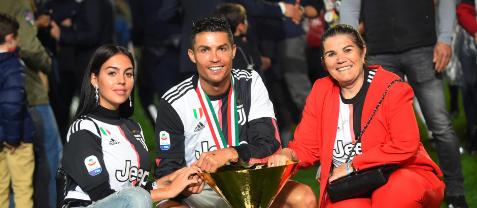 Juventus' Cristiano Ronaldo, center, is flanked by Georgina Rodriguez , left, and his mother Dolores Aveiro, right, after winning the Serie A soccer title trophy, at the Allianz Stadium, in Turin, Italy, Sunday, May 19, 2019.  *** Local Caption *** .