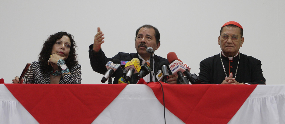 Nicaragua's President Daniel Ortega, center, speaks as he sits with First Lady Rosario Murillo, left, and Cardinal Miguel Obando y Bravo during a press conference at the Catholic University (UNICA) in Managua, Monday, May 11, 2009.