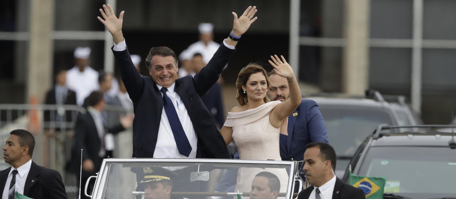 Brazil's new President Jair Bolsonaro and his wife Michelle Bolsonaro wave to the crowd in Brasilia, Brazil, Tuesday, Jan. 1, 2019.  *** Local Caption *** .
