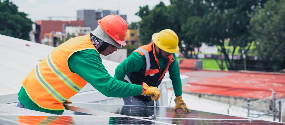 Obreros instalando paneles solares.