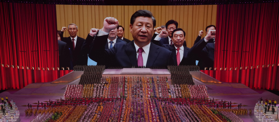 FILE - Chinese President Xi Jinping is seen leading other top officials pledging their vows to the party on screen during a gala show ahead of the 100th anniversary of the founding of the Chinese Communist Party in Beijing, June 28, 2021. Xi was dubbed "chairman of everything" after he put himself in charge of economic, propaganda and other major functions. That reversed a consensus for the ruling inner circle to avoid power struggles by sharing decision-making. (AP Photo/Ng Han Guan, File) 
China