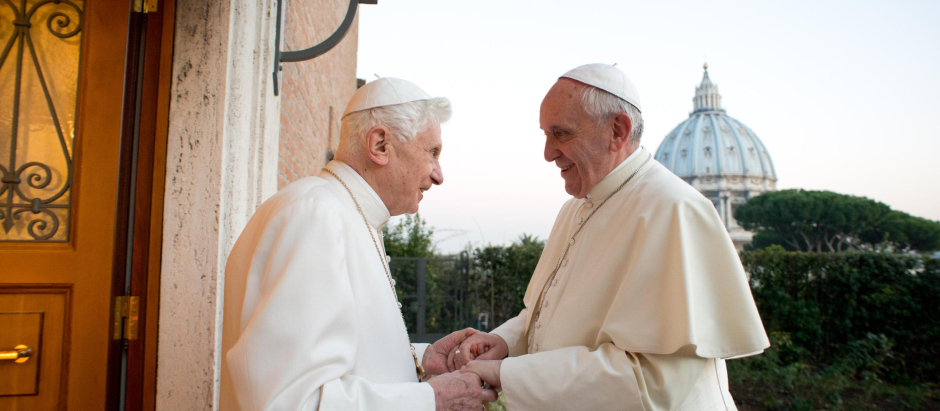 Pope Emeritus Benedict XVI, left, welcomes Pope Francis greetings, at the Vatican, Monday, Dec. 23, 2013.