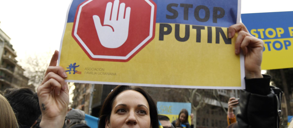 Una manifestante con una pancarta en contra de Putin