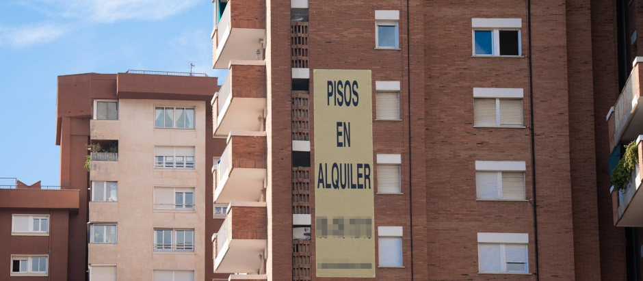 Cartel de alquiler de viviendas en la fachada de un edificio en Barcelona.
