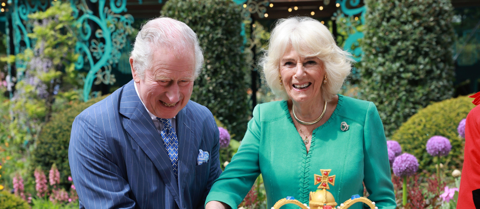 Britain's King Charles and Queen Camilla walk as they attend the opening of the new Coronation Garden in Newtownabbey, Northern Ireland, May 24, 2023.