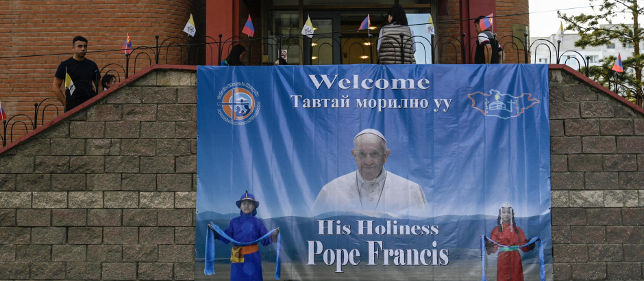 A poster with an image of Pope Francis hangs outside the bishops house in Ulaanbaatar on August 31, 2023. Pope Francis is set to visit Mongolia and tour the Buddhist-majority nation's capital at the government's invitation this week, becoming the first pontiff to set foot there. (Photo by Pedro PARDO / AFP)