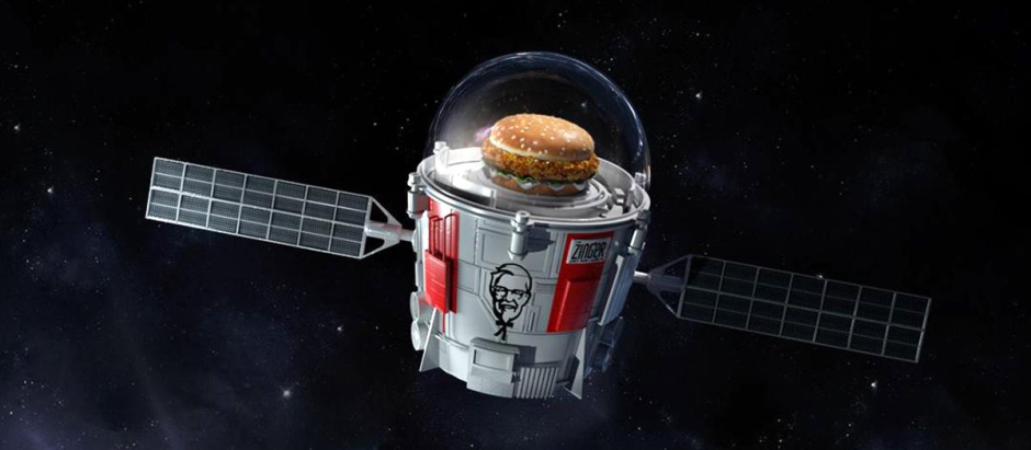 Concepto artístico de un satélite con publicidad de Kentucky Fried Chicken