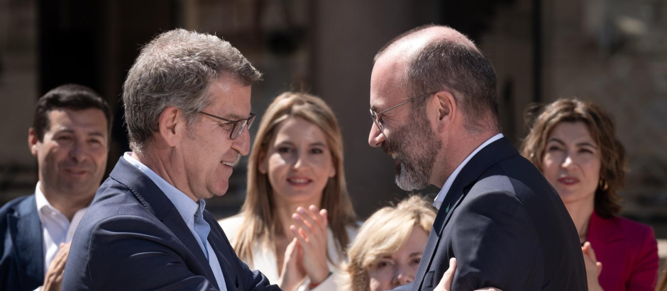 El presidente del PP, Alberto Núñez Feijóo, saluda al presidente del Partido Popular Europeo, Manfred Weber.