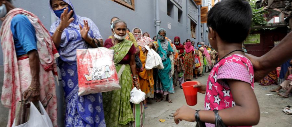 Personas en el este de la India reciben bolsas de comida en uno de los centros de Madre Teresa