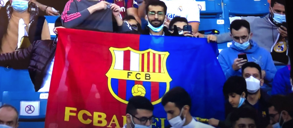 Un fanático del Barça levanta una bandera de su equipo en el que se ha borrado la cruz del escudo