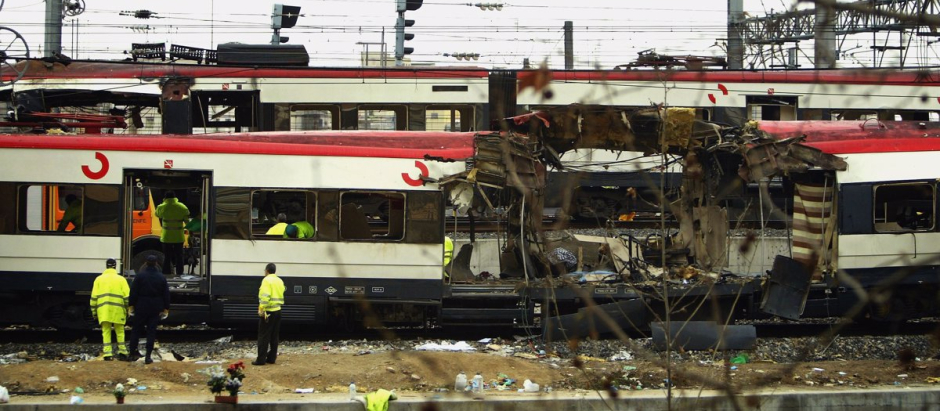 MADRID, SPAIN - MARCH 12:  One of the bomb damaged trains is towed past another at Atocha train station on March 12, 2004 in Madrid, Spain. According to judicial sources 198 people were killed in the series of three blasts.   (Photo by Bruno Vincent/Getty Images)