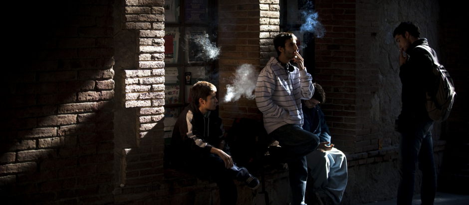 Students smoke at the courtyard of their university in Barcelona, Spain, Wednesday, Oct. 20, 2010.