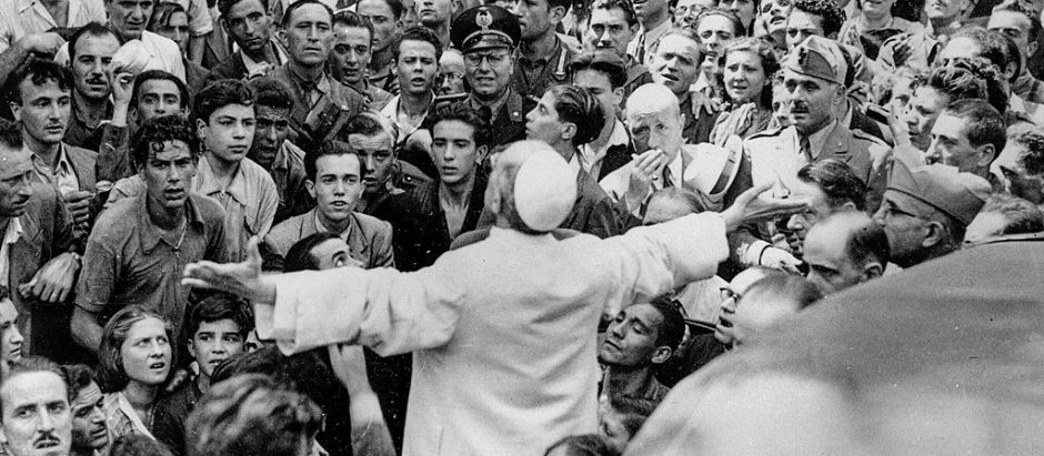In this Oct. 15, 1943 file photo, men, women and soldiers gather around Pope Pius XII, his arms outstretched, during his inspection tour of Rome, Italy, after the Aug. 13 American air raid during World War II. The Vatican’s chief librarian and archivists said Thursday, Feb. 20, 2020 that all researchers _ regardless of nationality, faith and ideology _ were welcome to request access to the soon-to-open Vatican’s apostolic library on Pope Pius XII starting March 2.  (AP Photo, file)