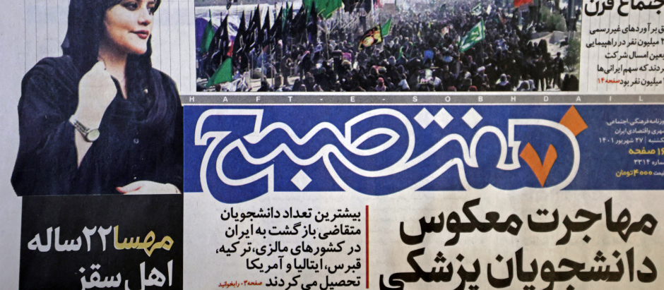 A picture taken in Tehran on September 18, 2022 shows the front page of the Iranian newspaper Hafteh Sobh featuring a photograph of Mahsa Amini, a woman who died after being arrested by the Islamic republic's "morality police" two days ago. - Amini, 22, was on a visit with her family to the Iranian capital when she was detained on September 13 by the police unit responsible for enforcing Iran's strict dress code for women, including the wearing of the headscarf in public. She was declared dead on September 16 by state television after having spent three days in a coma. (Photo by ATTA KENARE / AFP)