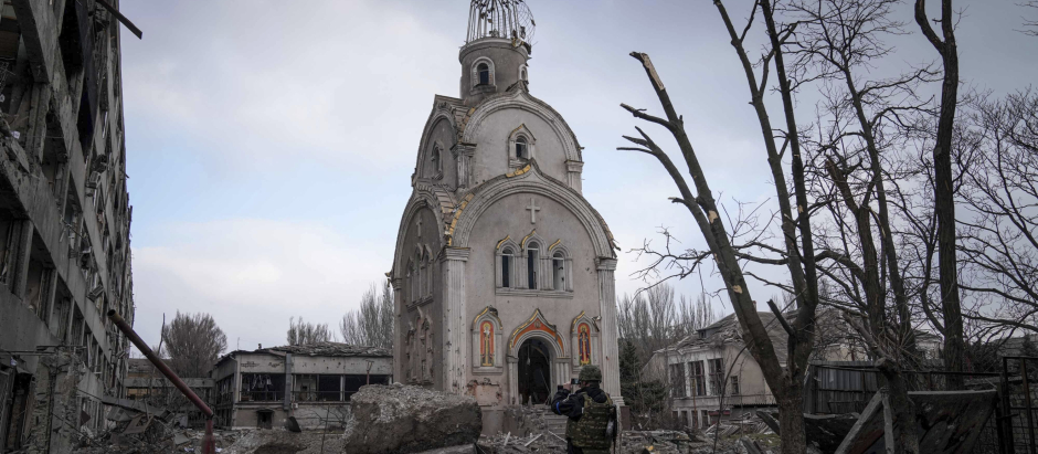 A Ukrainian serviceman takes a photograph of a damaged church after shelling in a residential district in Mariupol, Ukraine, Thursday, March 10, 2022. (AP Photo/Evgeniy Maloletka)