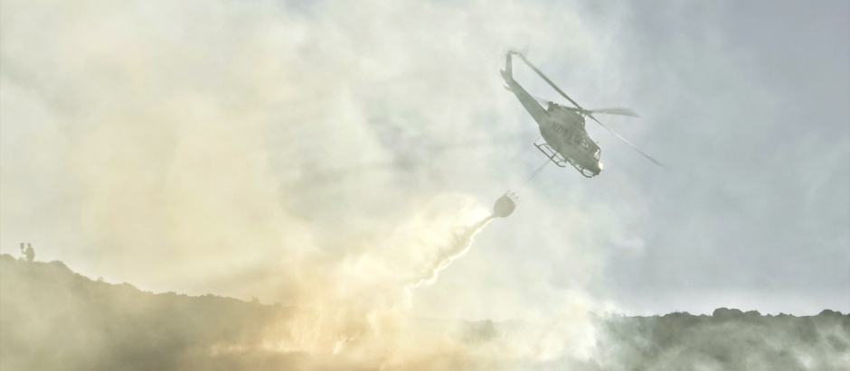 Un helicóptero trabaja en las labores de extinción de un incendio forestal en Asturias