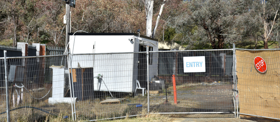 A portable security shed surrounded by weeds and discarded building materials is seen on a vacant land, which is a proposed new Russian embassy site, in Canberra on June 23, 2023. A mystery Russian diplomat with a penchant for cigarettes on Friday sparked a national security standoff between Canberra and the Kremlin, which is defying Australia's efforts to kick him off a messy building site near parliament. (Photo by Yoann CAMBEFORT / AFP)