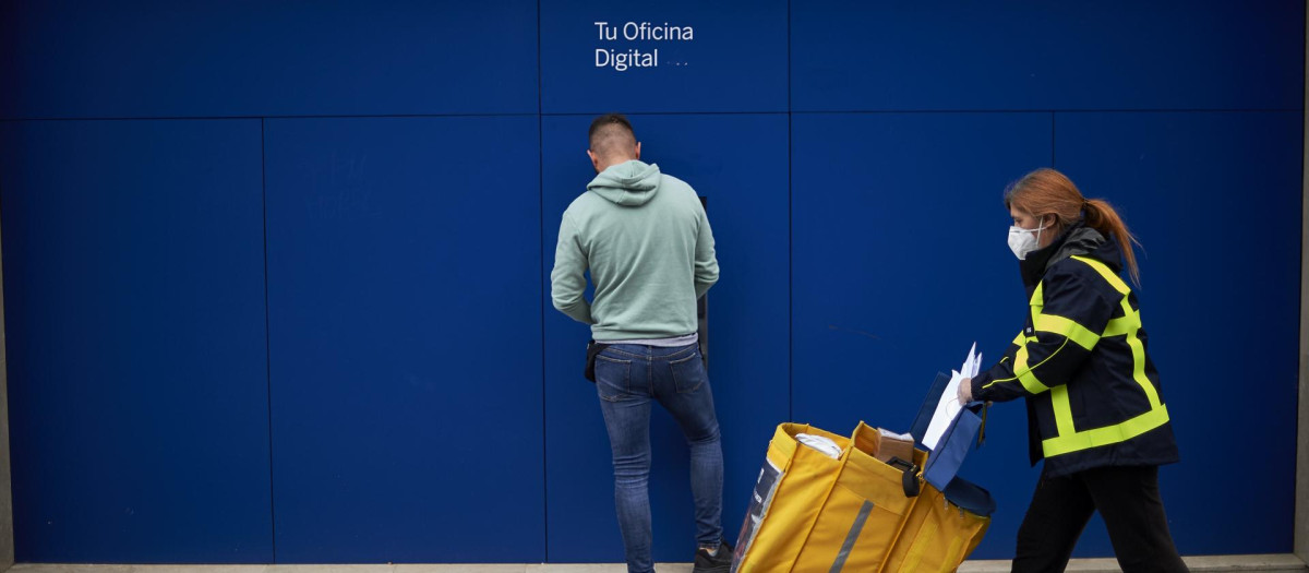 Un hombre retira efectivo de un cajero de BBVA