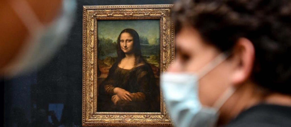 Dos personas llevan mascarillas en el Museo del Louvre