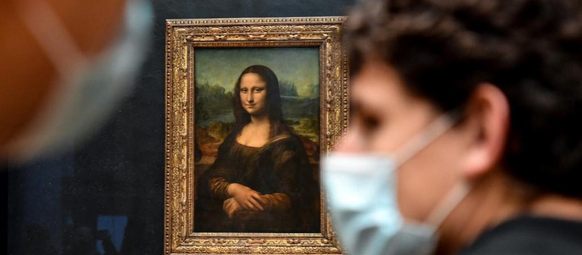 Dos personas llevan mascarillas en el Museo del Louvre