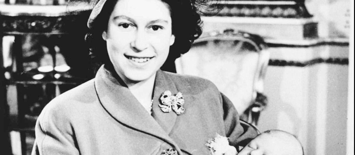 Britain's Queen Elizabeth pictured with her first son, Prince Charles, at Buckingham Palace on the day of his Christening December 15 1948.