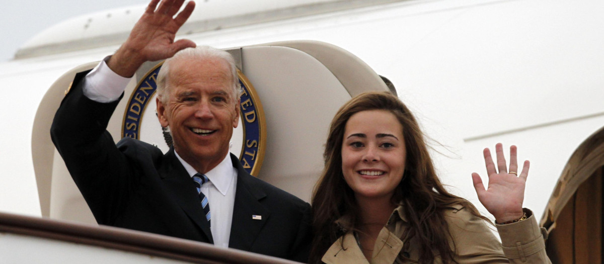 U.S. Vice President Joseph Biden, left, waves with his granddaughter Naomi Biden as they walk out from Air Force Two upon arrival at the airport in Beijing, China, Wednesday, Aug. 17, 2011. (AP Photo/Ng Han Guan, POOL)