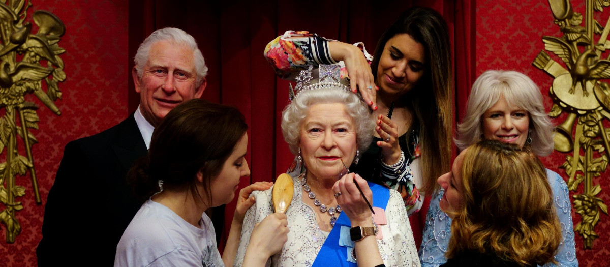Studio artists Luisa Compobassi (left), Caryn Mitanni (back) and Jo Kinsey (right) make their final touches to the wax figure of Queen Elizabeth II at Madame Tussauds London ahead the Platinum Jubilee celebrations. Picture date: Wednesday May 25, 2022.