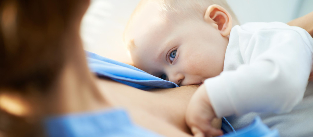 Close-up of woman breastfeeding her small son