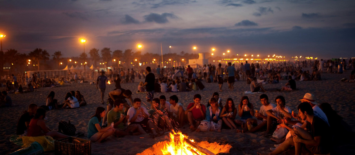 Men and women sit around a fire as they celebrate the San Juan night at a beach in Valencia, Spain, Thursday, June 23, 2011. The San Juan night coincides with the shortest night of the year, and ushers in the start of summer in many cities and towns in Spain