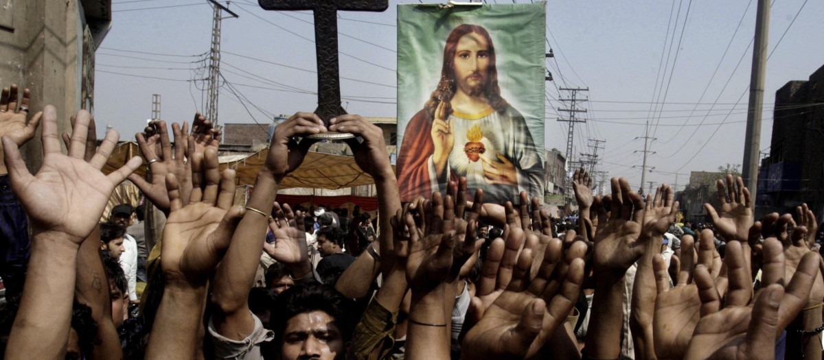 Pakistani Christians raise their hands during a demonstration in Lahore, Pakistan, Sunday, March 10, 2013. Hundreds of Christians protesting the burning of their homes by a Muslim mob over alleged blasphemous remarks made against the Islam's Prophet Muhammad clashed with police on Sunday in eastern and southern Pakistan.