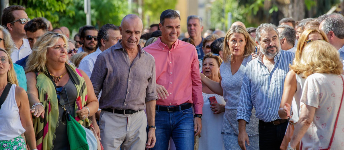 El secretario general del PSOE y presidente del Gobierno, Pedro Sánchez (c), y el alcalde de Sevilla, Antonio Muñoz (i), con vecinos del sevillano barrio de Pino Montano antes de participar en el primer acto de la campaña 'El Gobierno de la Gente', que se celebra en Sevilla