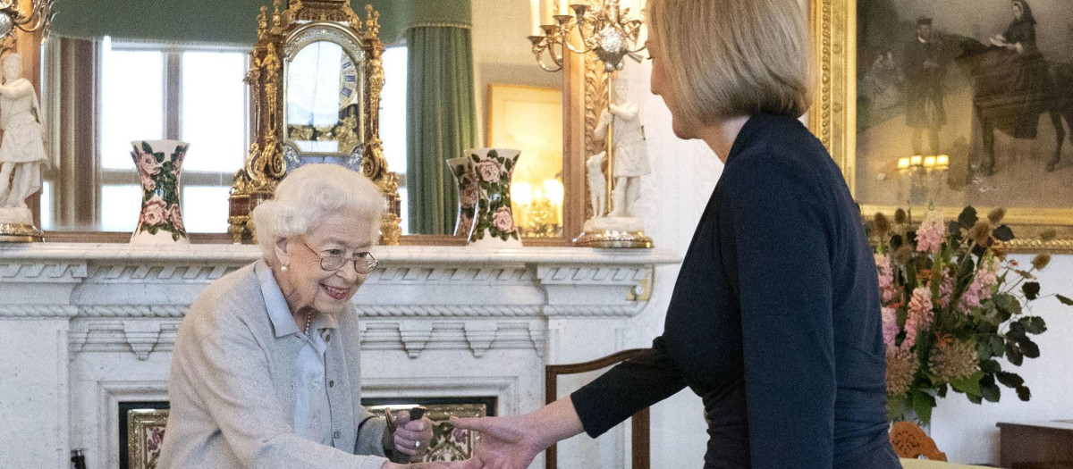 Britain's Queen Elizabeth II, left, welcomes Liz Truss during an audience at Balmoral, Scotland, where she invited the newly elected leader of the Conservative party to become Prime Minister and form a new government, Tuesday, Sept. 6, 2022.