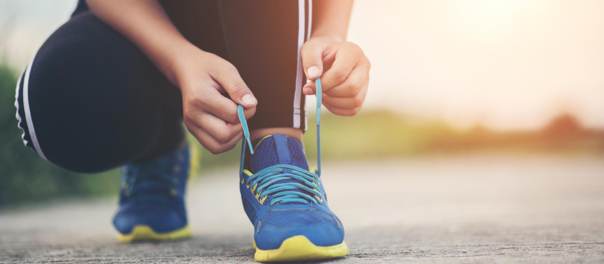 Close up shoes Female runner tying her shoes for a jogging exercise