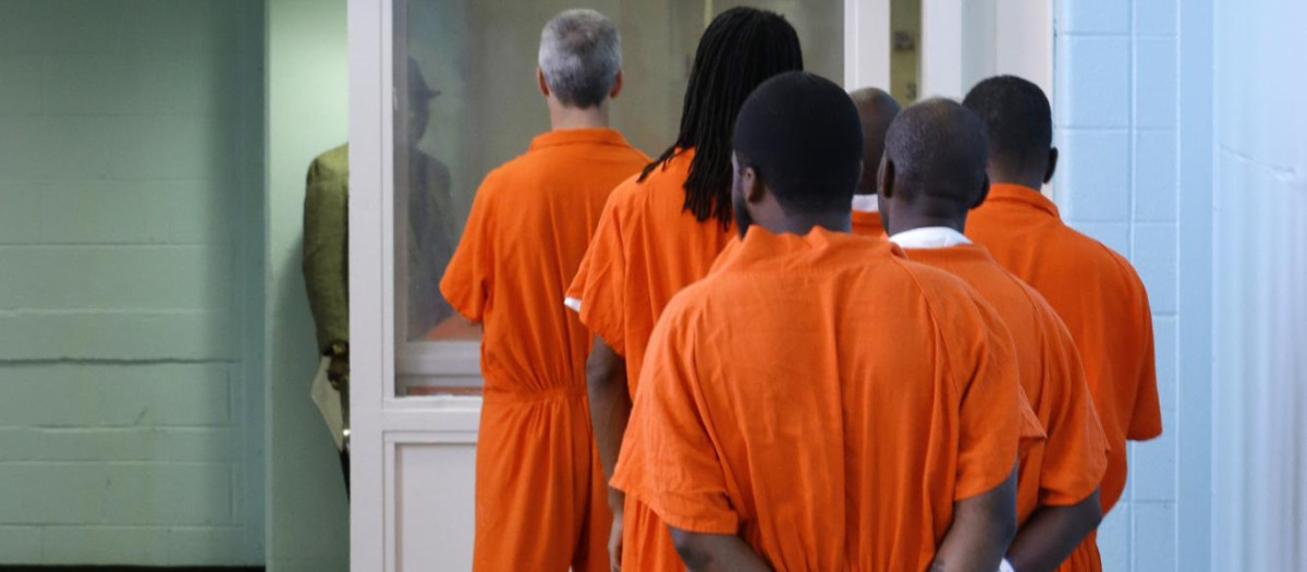 Prisoners line up to vote at the D.C. Jail in Washington. The voters at this southeast Washington polling place were all dressed alike: orange jumpsuit, white shoes.