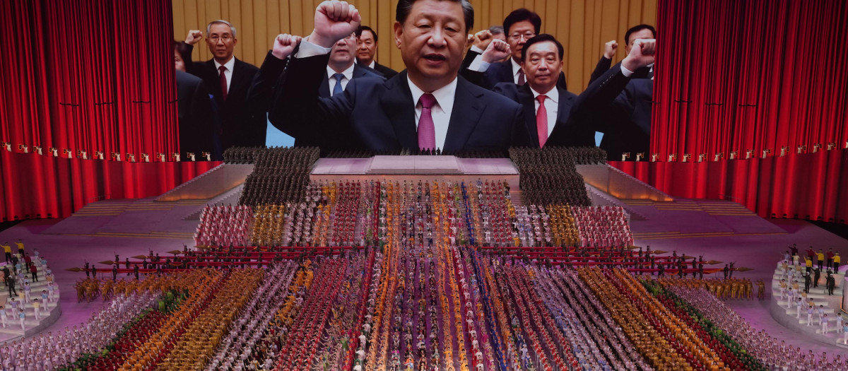 FILE - Chinese President Xi Jinping is seen leading other top officials pledging their vows to the party on screen during a gala show ahead of the 100th anniversary of the founding of the Chinese Communist Party in Beijing, June 28, 2021. Xi was dubbed "chairman of everything" after he put himself in charge of economic, propaganda and other major functions. That reversed a consensus for the ruling inner circle to avoid power struggles by sharing decision-making. (AP Photo/Ng Han Guan, File) 
China