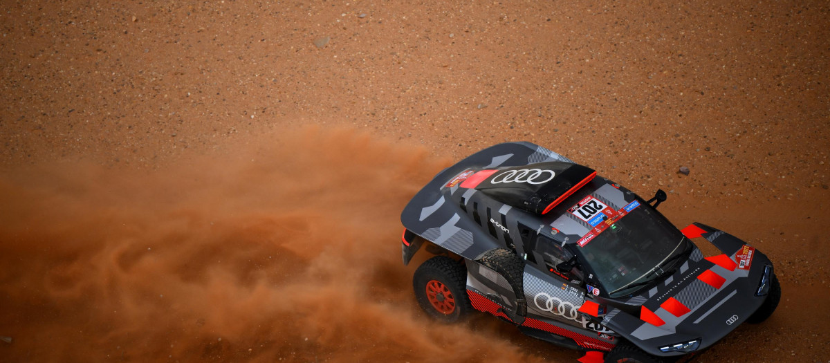 Audi's hybrid Spanish drivers Carlos Sainz and co-driver Lucas Cruz compete during the Stage 3 of the Dakar 2023 rally between al-Ula and Hail in Saudi Arabia on January 3, 2023. (Photo by FRANCK FIFE / AFP)