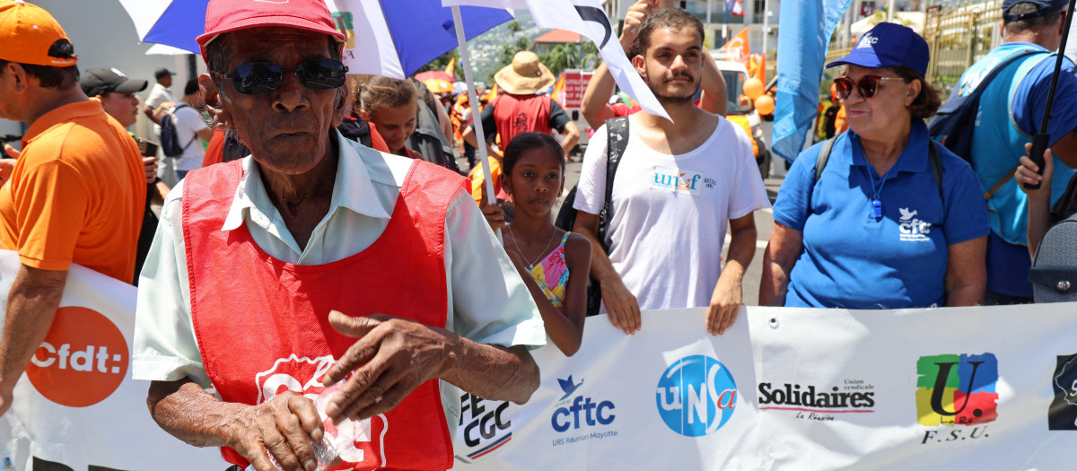 Protesters attend a demonstration on the fourth day of nationwide rallies organised since the start of the year, against a deeply unpopular pensions overhaul, in Saint-Denis de la Reunion on the French Indian island of La Reunion on February 11, 2023. (Photo by Richard BOUHET / AFP)