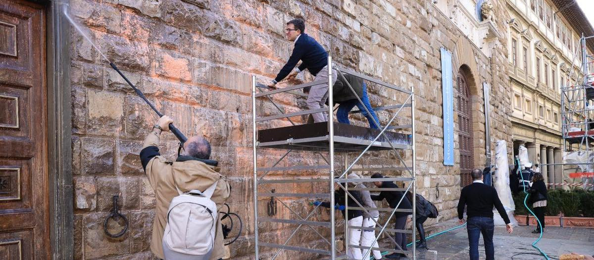 El alcalde, junto a voluntarios, limpiando la fachada del Palacio Vecchio