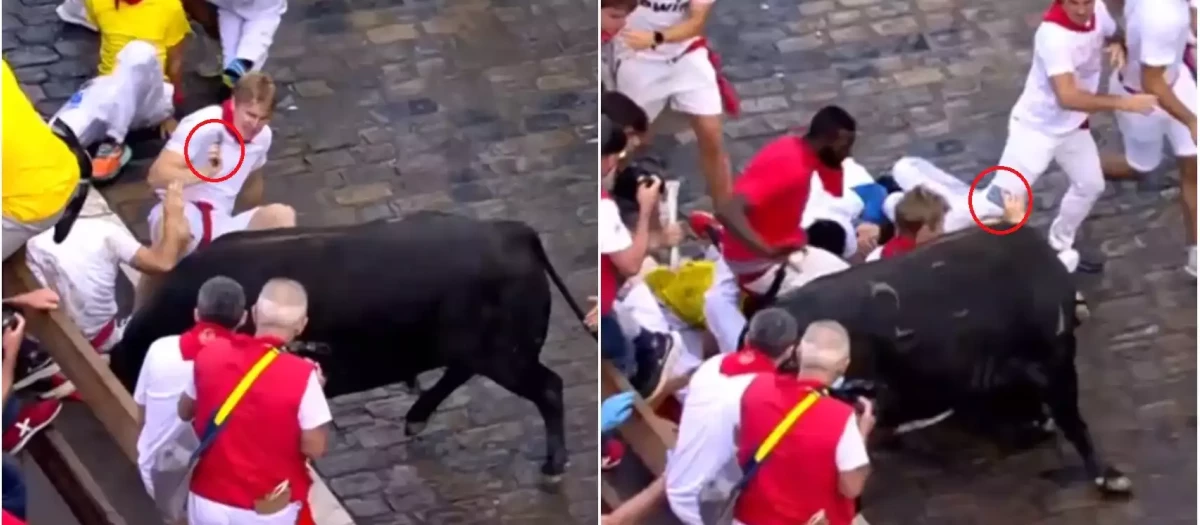 Un joven graba con su teléfono móvil mientras corre el tercer encierro de San Fermín