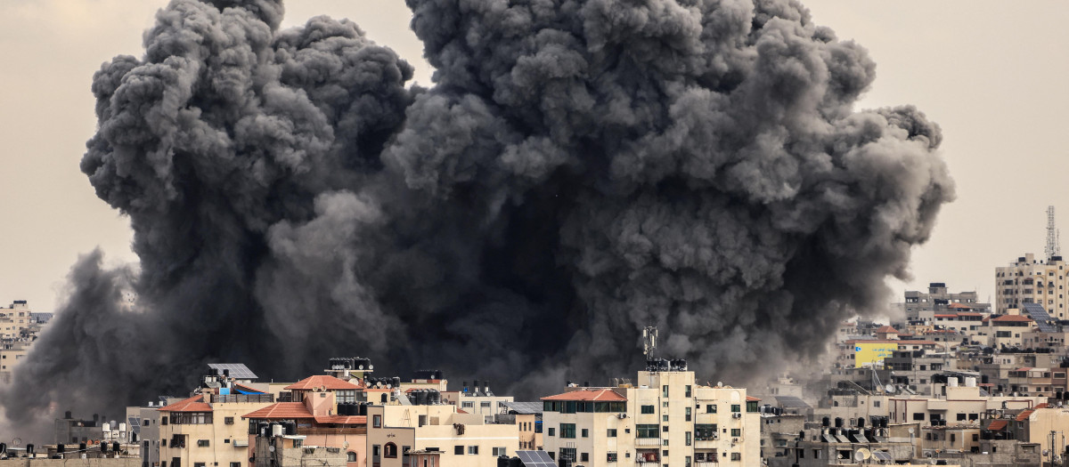 A plume of smoke rises in the sky of Gaza City during an Israeli airstrike on October 9, 2023. - Israel relentlessly pounded the Gaza Strip overnight and into October 9 as fighting with Hamas continued around the Gaza Strip, as the death toll from the war against the Palestinian militants surged above 1,100. (Photo by MAHMUD HAMS / AFP)