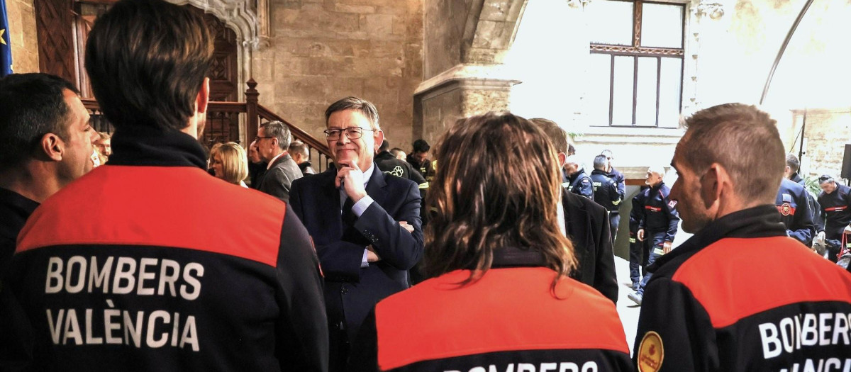 El expresidente de la Generalitat Valenciana Ximo Puig, junto a un grupo de bomberos, el pasado febrero