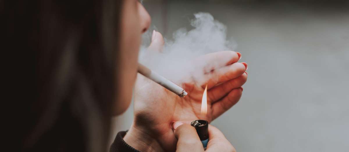 Mujer encendiéndose un cigarrillo