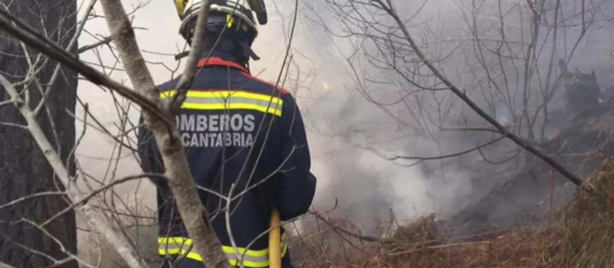 Imagen de archivo de un bombero sofocando un fuego en Cantabria