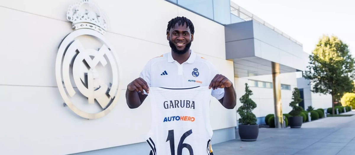 Usman Garuba posando con la camiseta del Real Madrid en Valdebebas