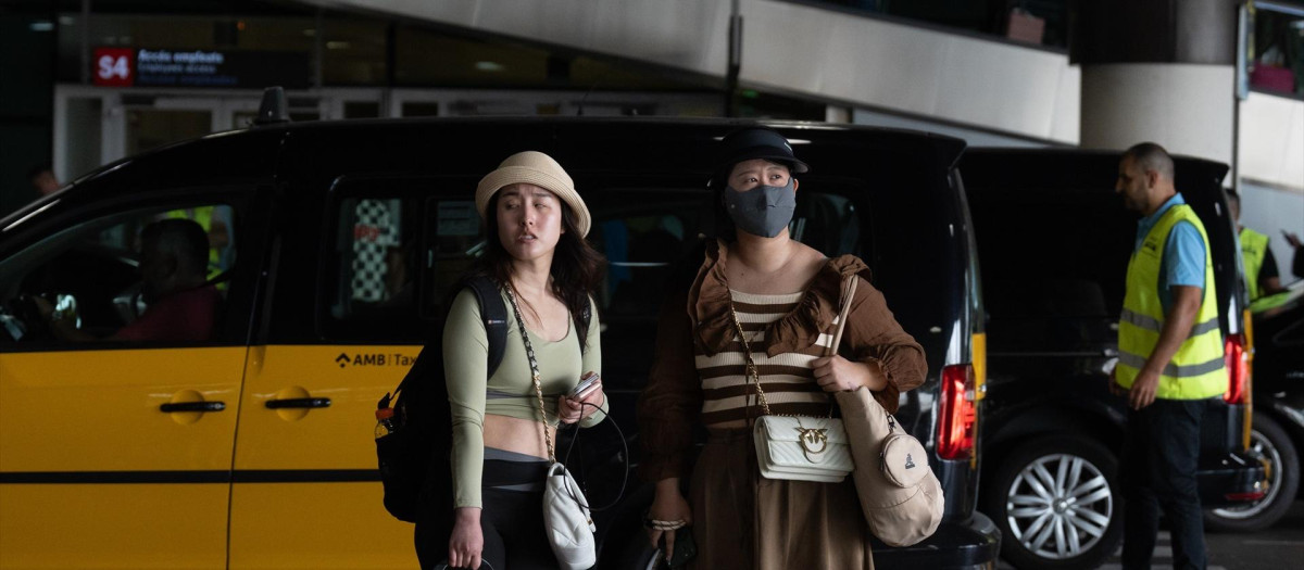 (Foto de ARCHIVO)
Turistas en el aeropuerto de Barcelona con la concentración de taxistas al fondo

DAVID ZORRAKINO-EUROPA PRESS
28/6/2024