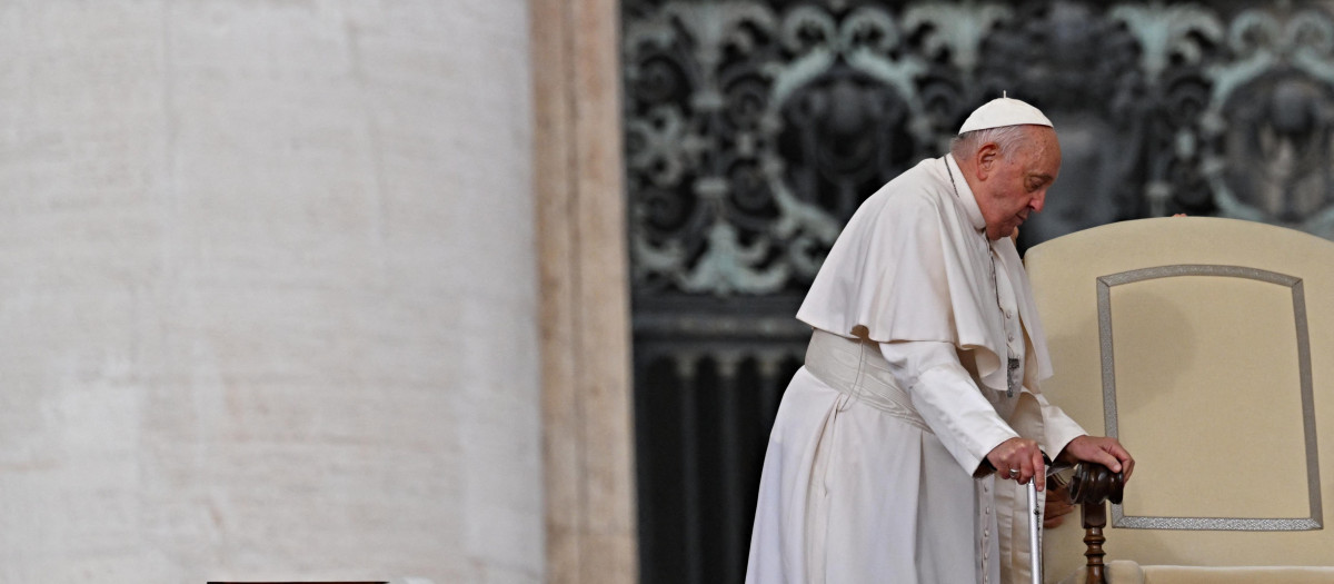 Pope Francis using a walking stick arrives for the weekly general audience at Saint Peter's Square in The Vatican on October 16, 2024. (Photo by Andreas SOLARO / AFP)