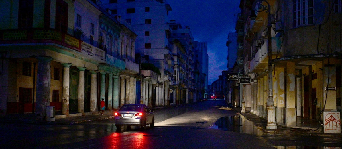 Un coche circula por una calle durante el apagón total que sufre Cuba