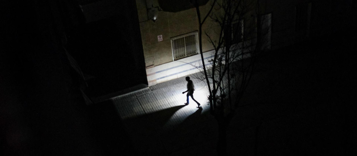 Un vecino de Elche camina con una linterna durante el apagón eléctrico.