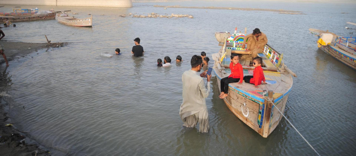 Un grupo de personas reunidas en el río Indo cerca de Hyderabad, provincia de Sindh, Pakistán