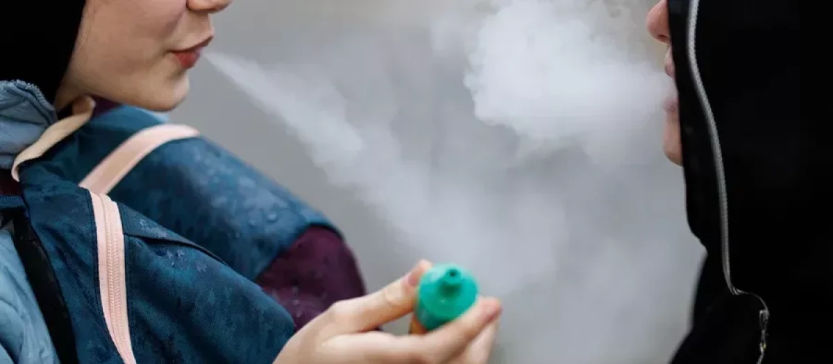 Fotografía de archivo de jóvenes utilizando vapeadores